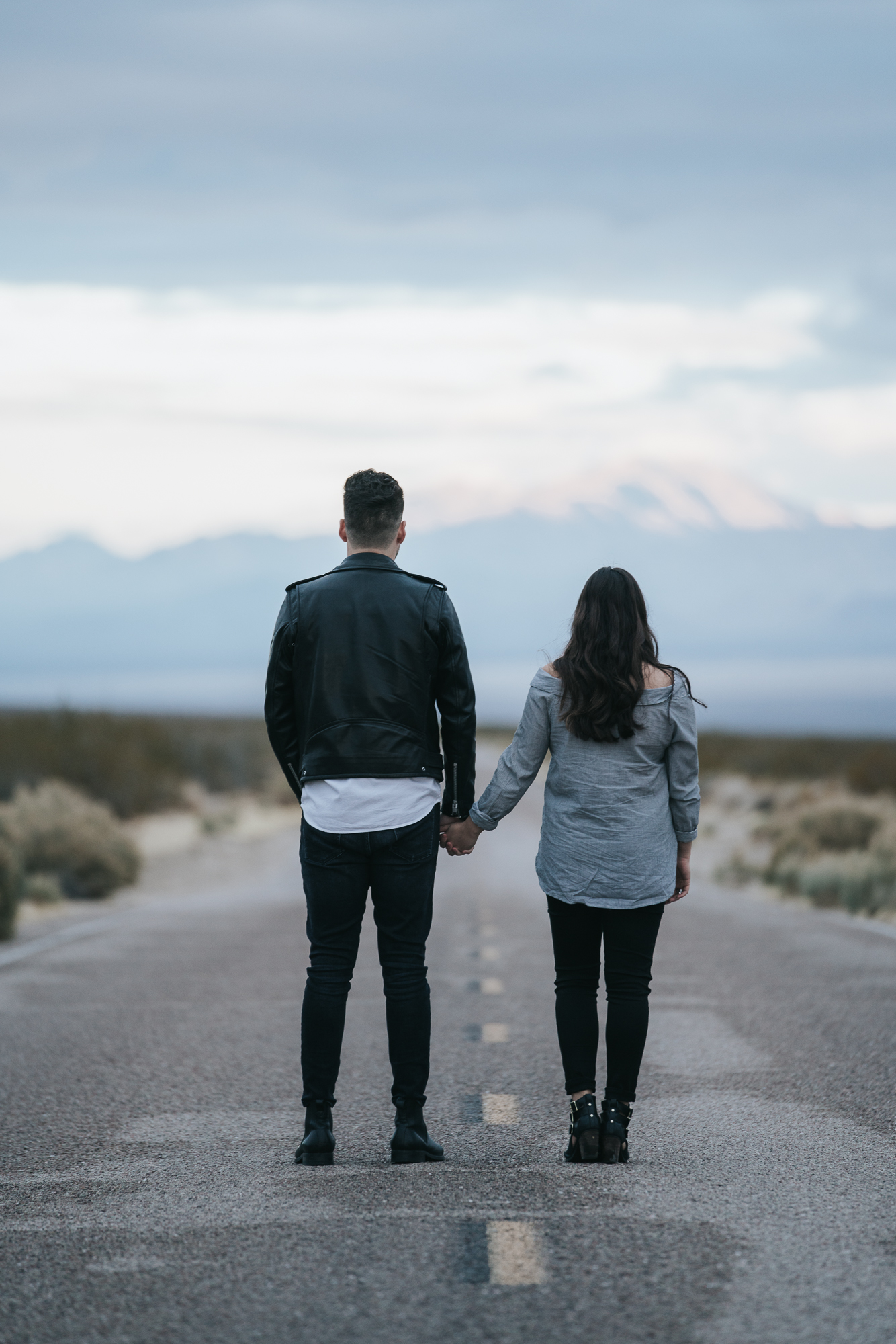 holding hands standing in street Mojave desert