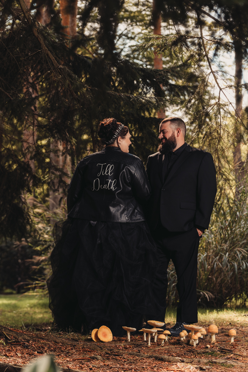 gothic bride and groom outdoors for halloween wedding